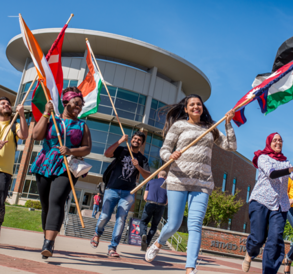 International Students carrying their flags.